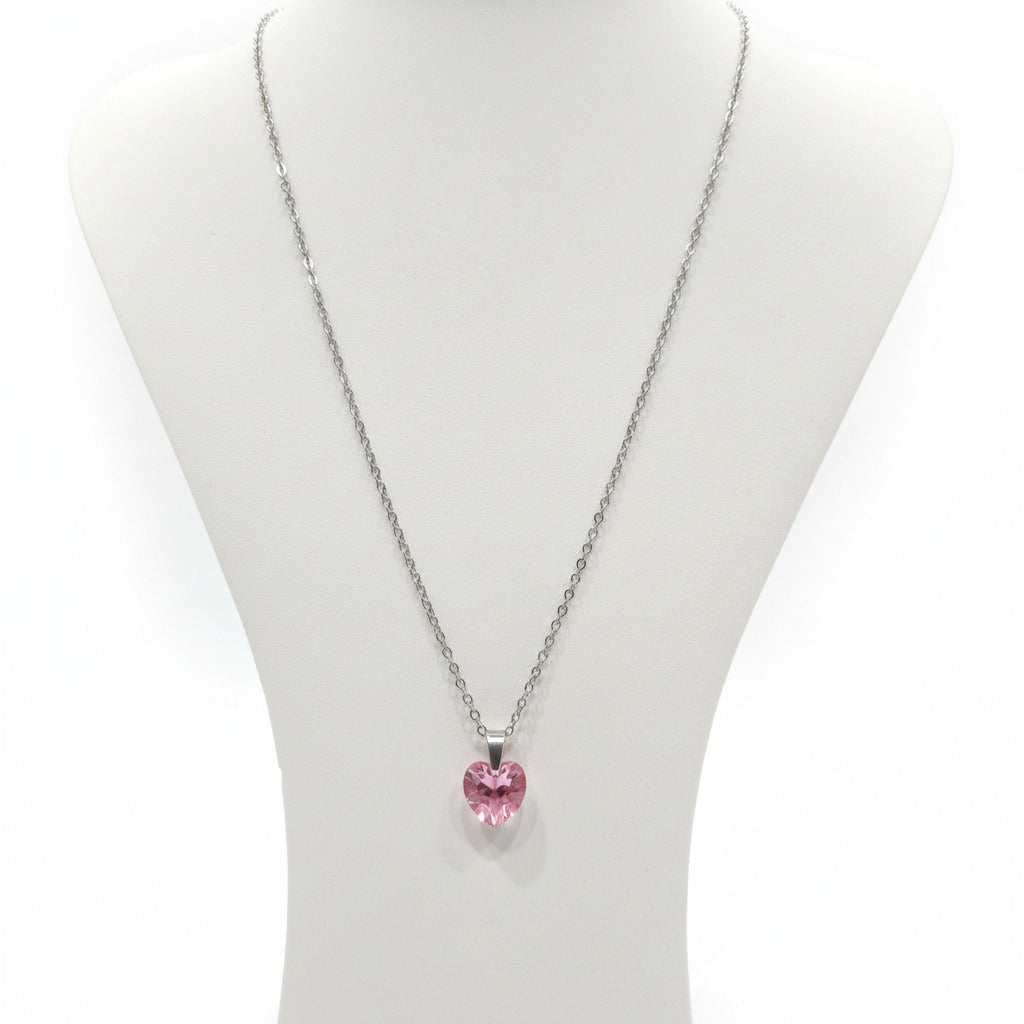 Necklace with a pink heart-shaped pendant on a white card