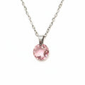 Pink crystal on silver color necklace on a plain background