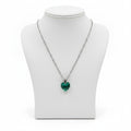 Necklace with a green heart-shaped pendant on a white background