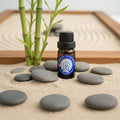 Bottle of diffuser blend essential oil with stones and bamboo in the background