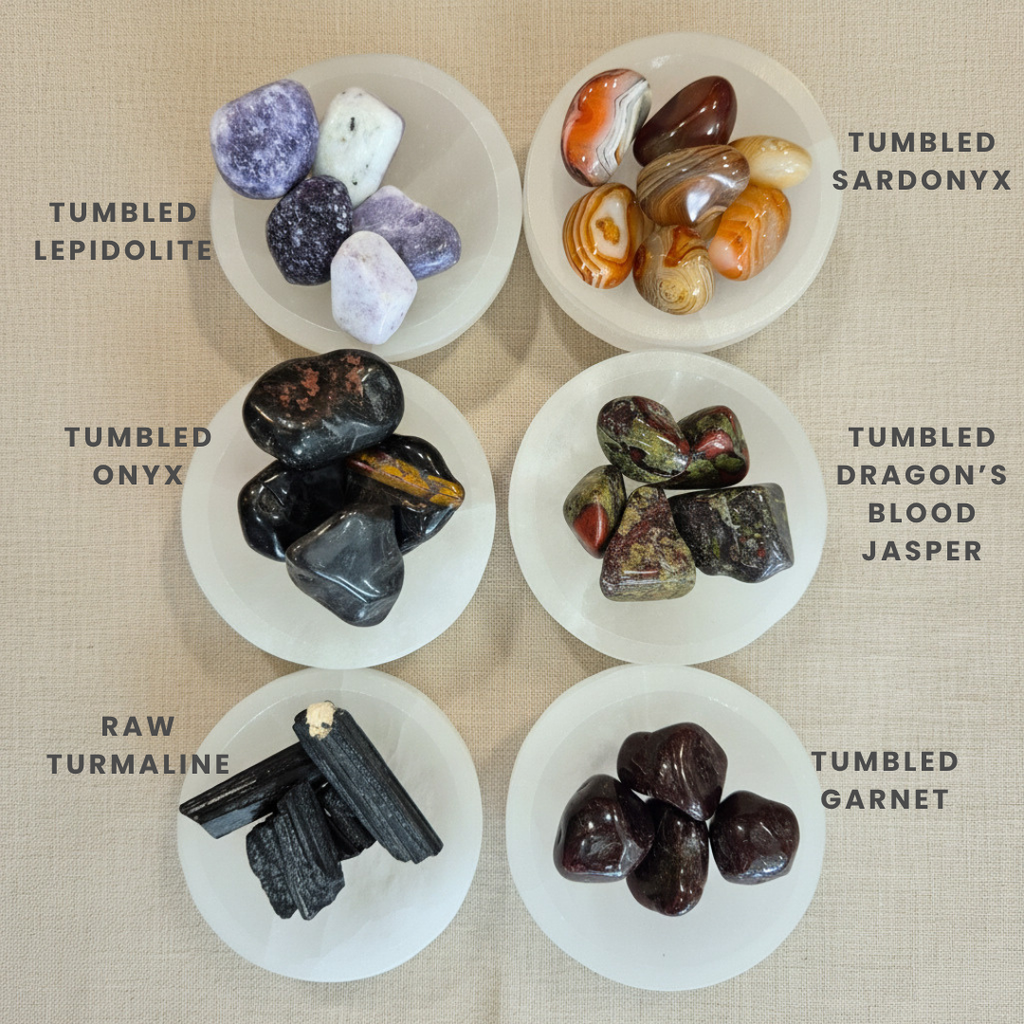 Collection of tumbled gemstones on a beige background with labels.