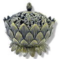 Decorative incense holder with intricate designs on a white background