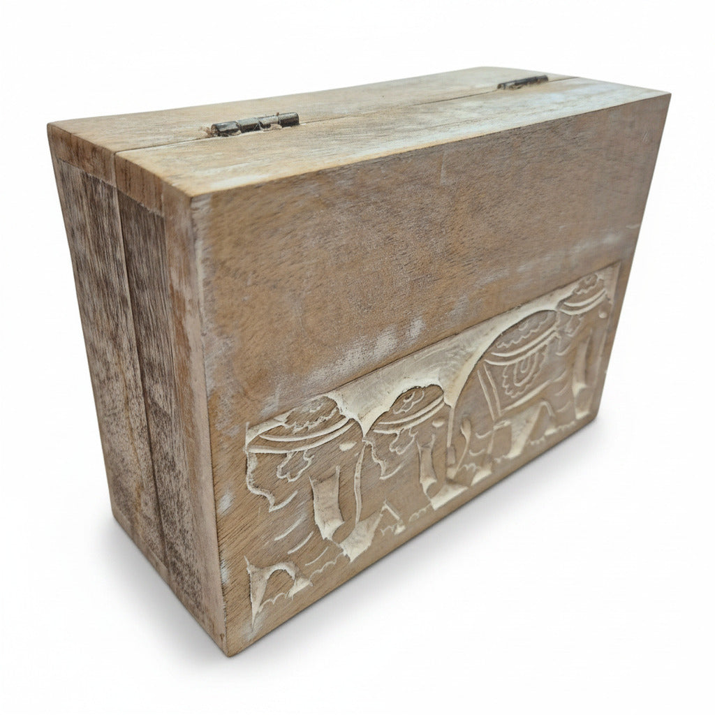 Wooden box with intricate carvings on a white background